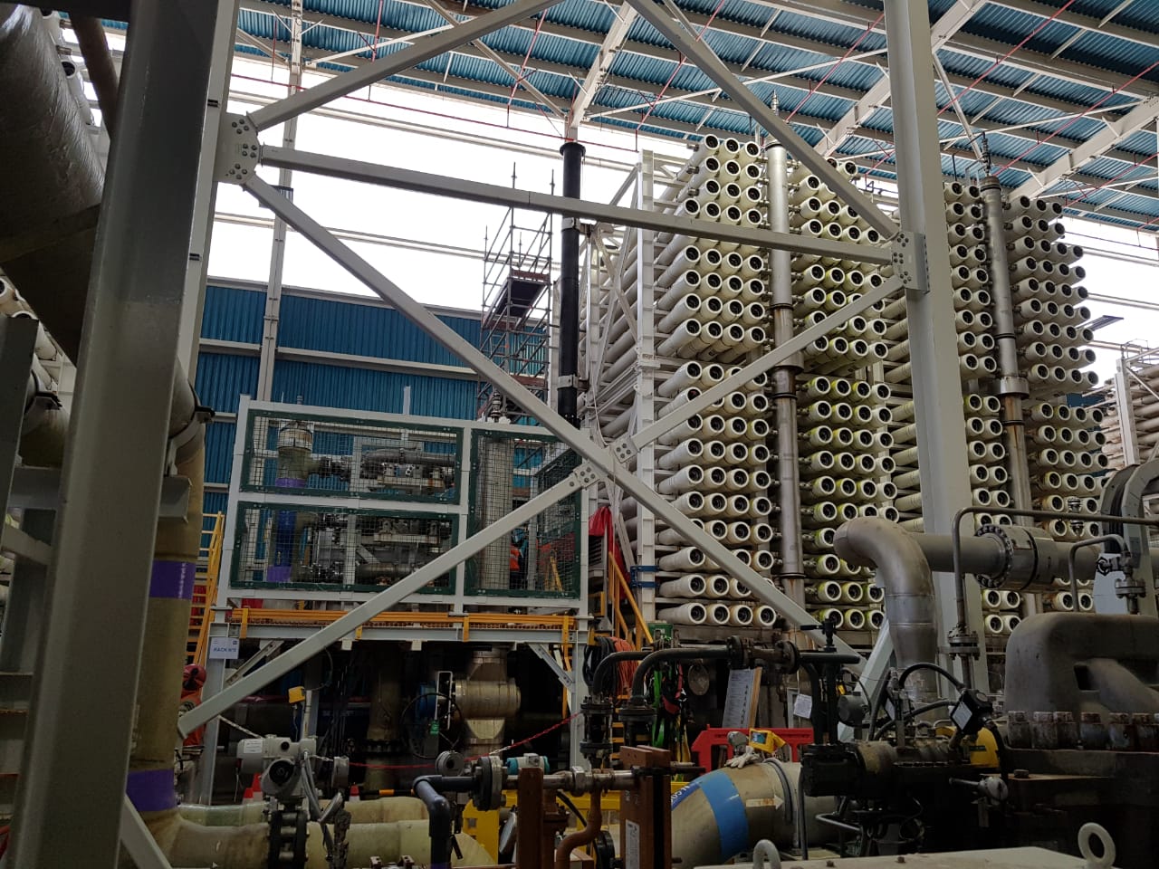 cs-procure-desalination-chimney Figure 1: Image of one of the nine Reverse Osmosis (RO) racks as the chimney was being installed.